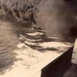Smokescreen hiding the wake of HMS Kent while it was under attack