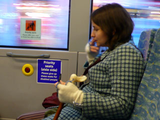 Kate finds her place in one of the priority seats on the bus