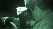 Cameraman filming at night