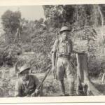 Private Benjamin Gee with Private Hopkins in February 1942 taking refuge on the island. Japanese fighters had just caused the damage to the trees in the background.