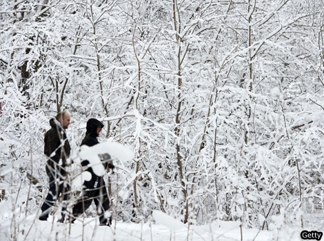 Two people walking in the snow